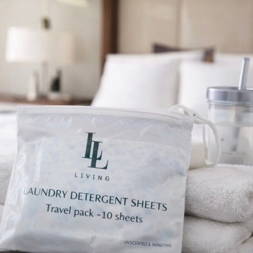 Package of laundry detergent sheets with a bed in the background