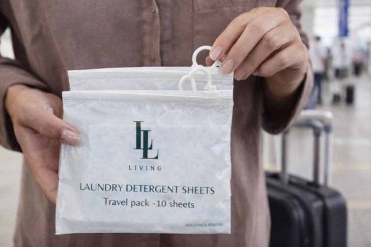 Person holding a package of laundry detergent sheets with 'LL Living' branding.