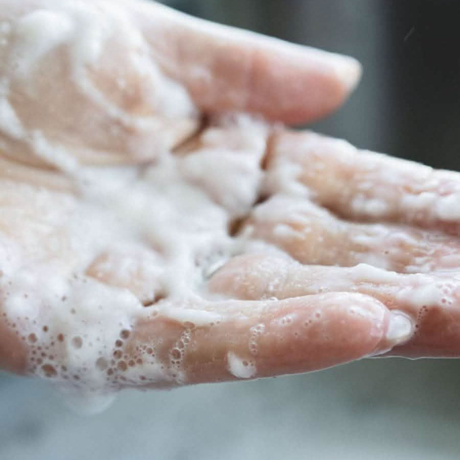 laundry detergent suds in hand