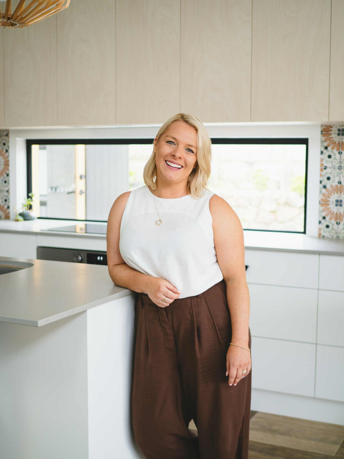 woman standing in kitchen for headshot