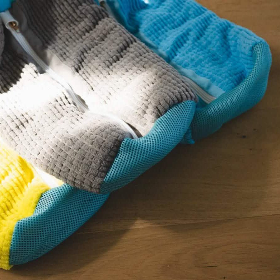 Blue and gray protective wash bags on a wooden floor