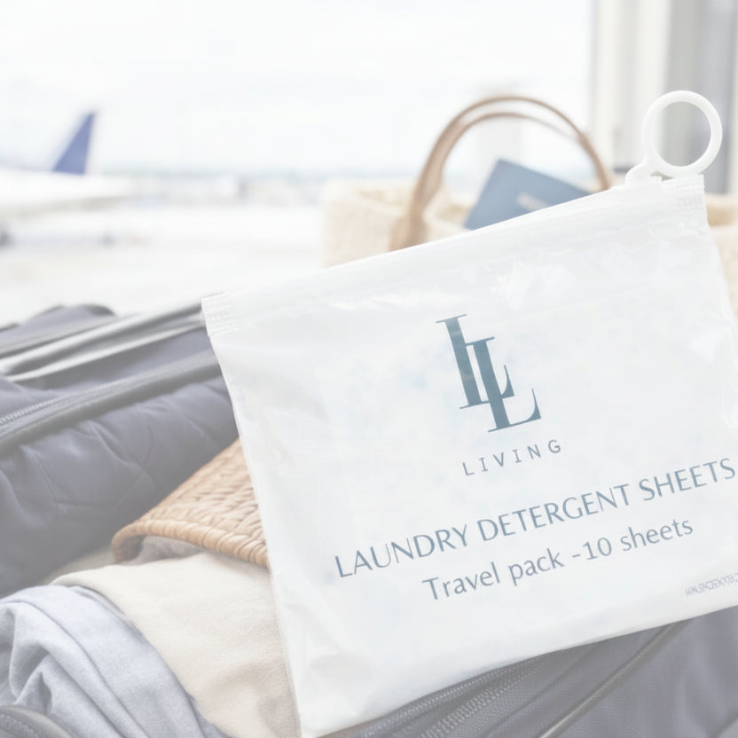 Travel pack of laundry detergent sheets with 'LL Living' logo on a suitcase at an airport.