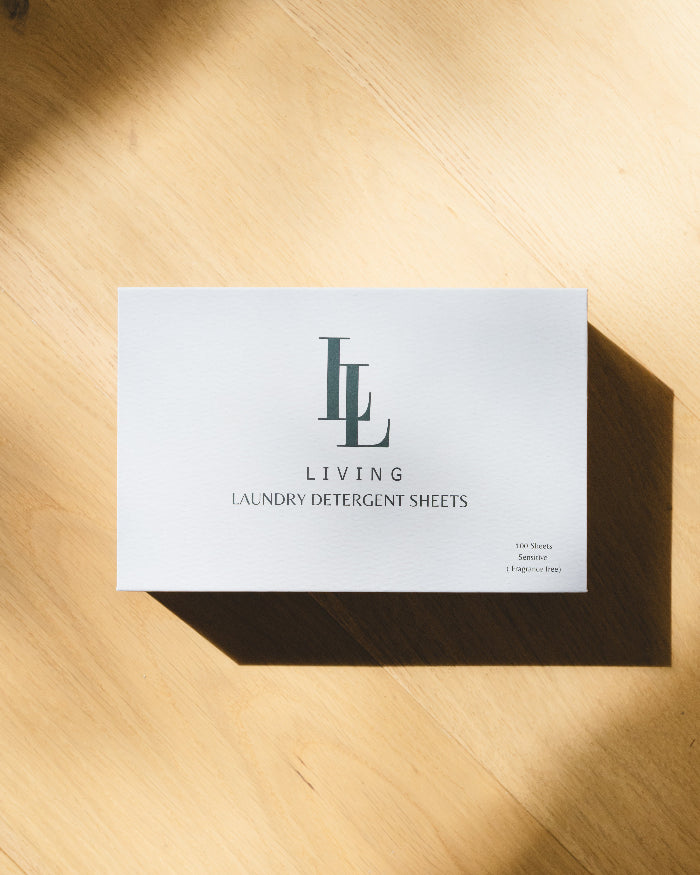 Box of hypoallergenic, eco-friendly Living laundry detergent sheets on a wooden surface