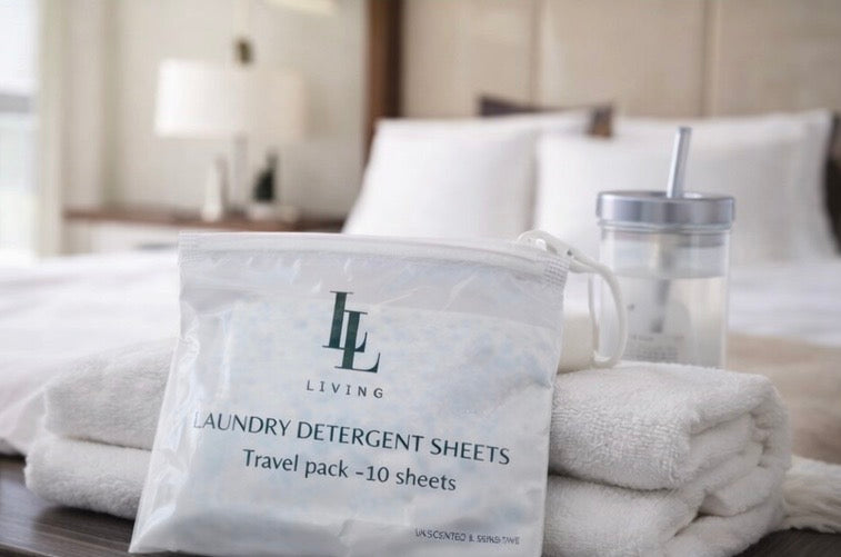 Package of laundry detergent sheets with a bed in the background