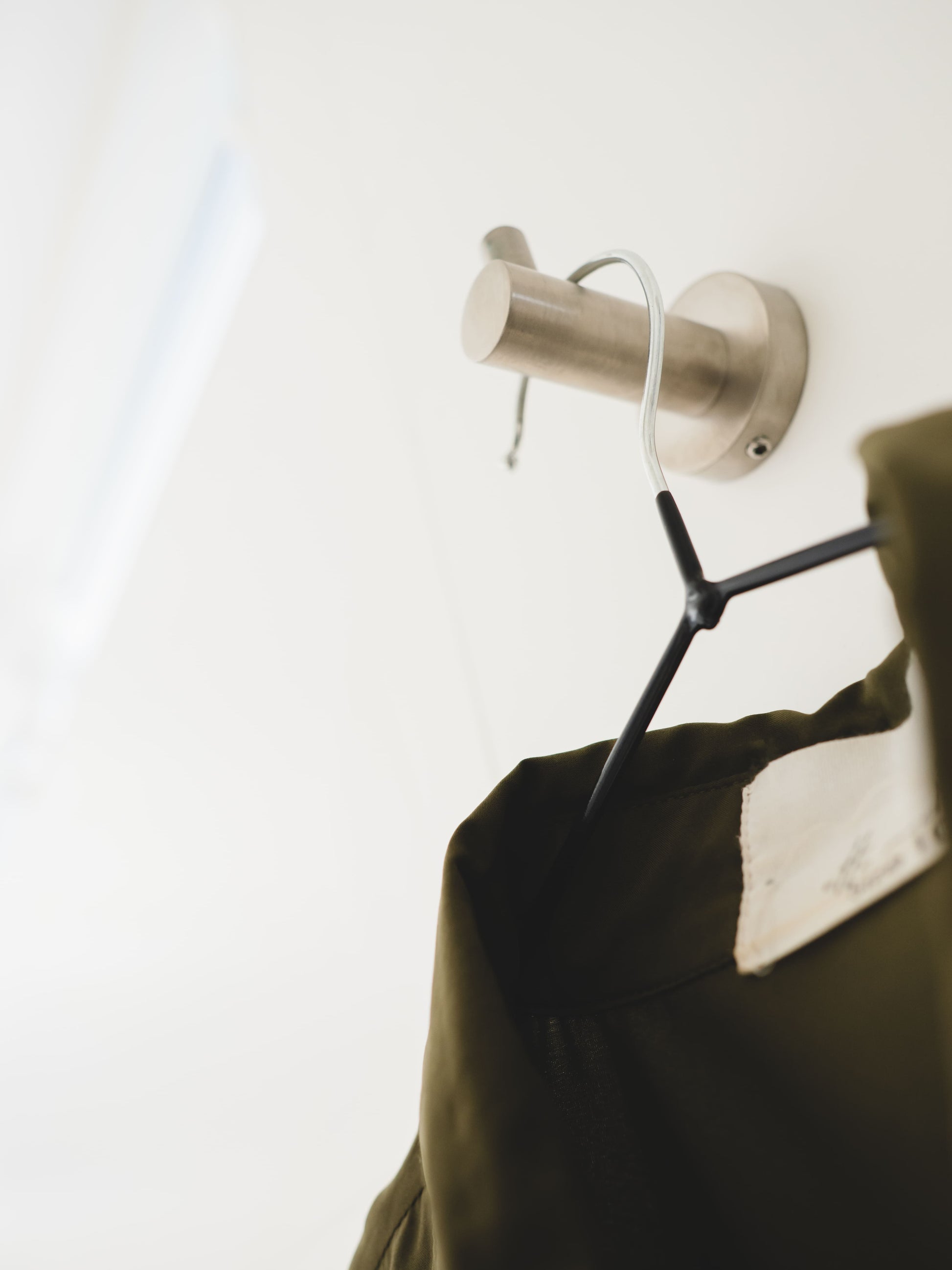 close up of coat hanger on hook