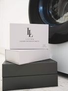 detergent sheet boxes displayed in front of washing machine