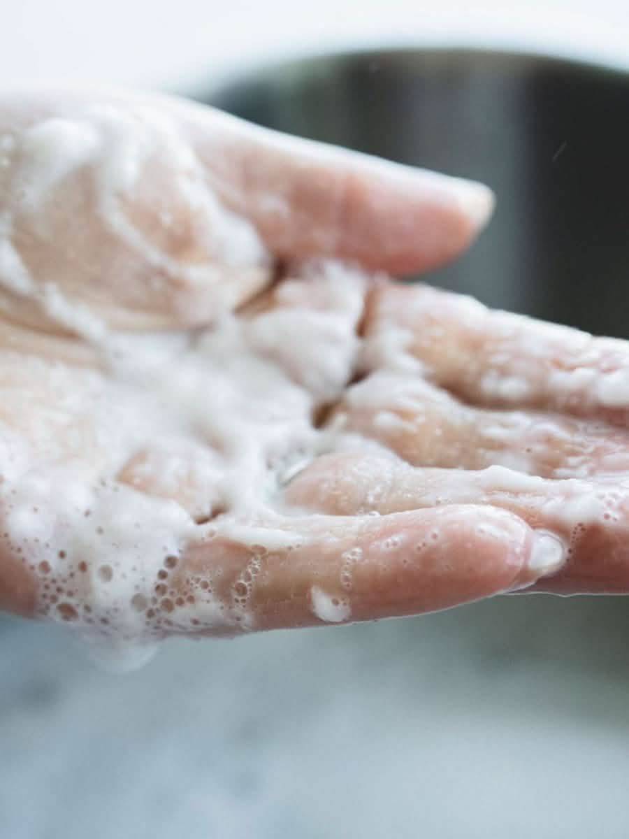 laundry detergent suds in hand