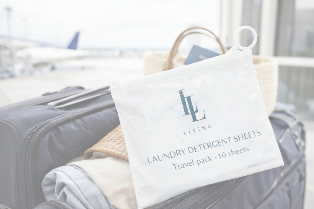 Travel pack of laundry detergent sheets with 'LL Living' logo on a suitcase at an airport.