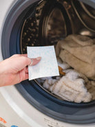 unscented detergent sheet getting placed in machine of towels