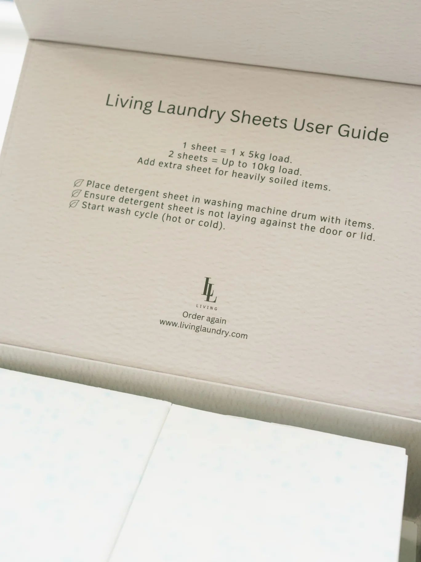 Living Laundry Sheets User Guide with instructions and branding on a beige background