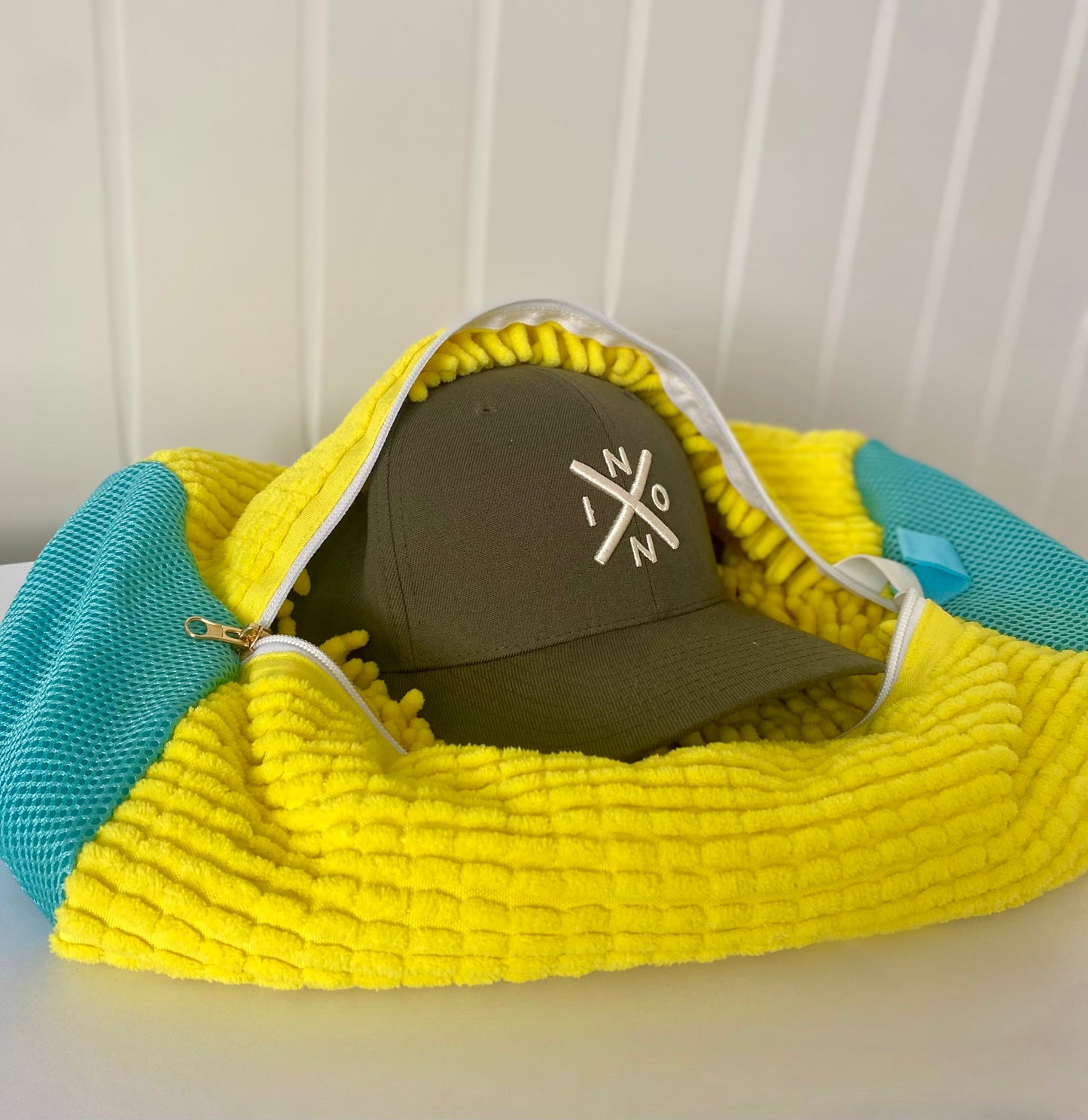 yellow wash bag with green hat inside